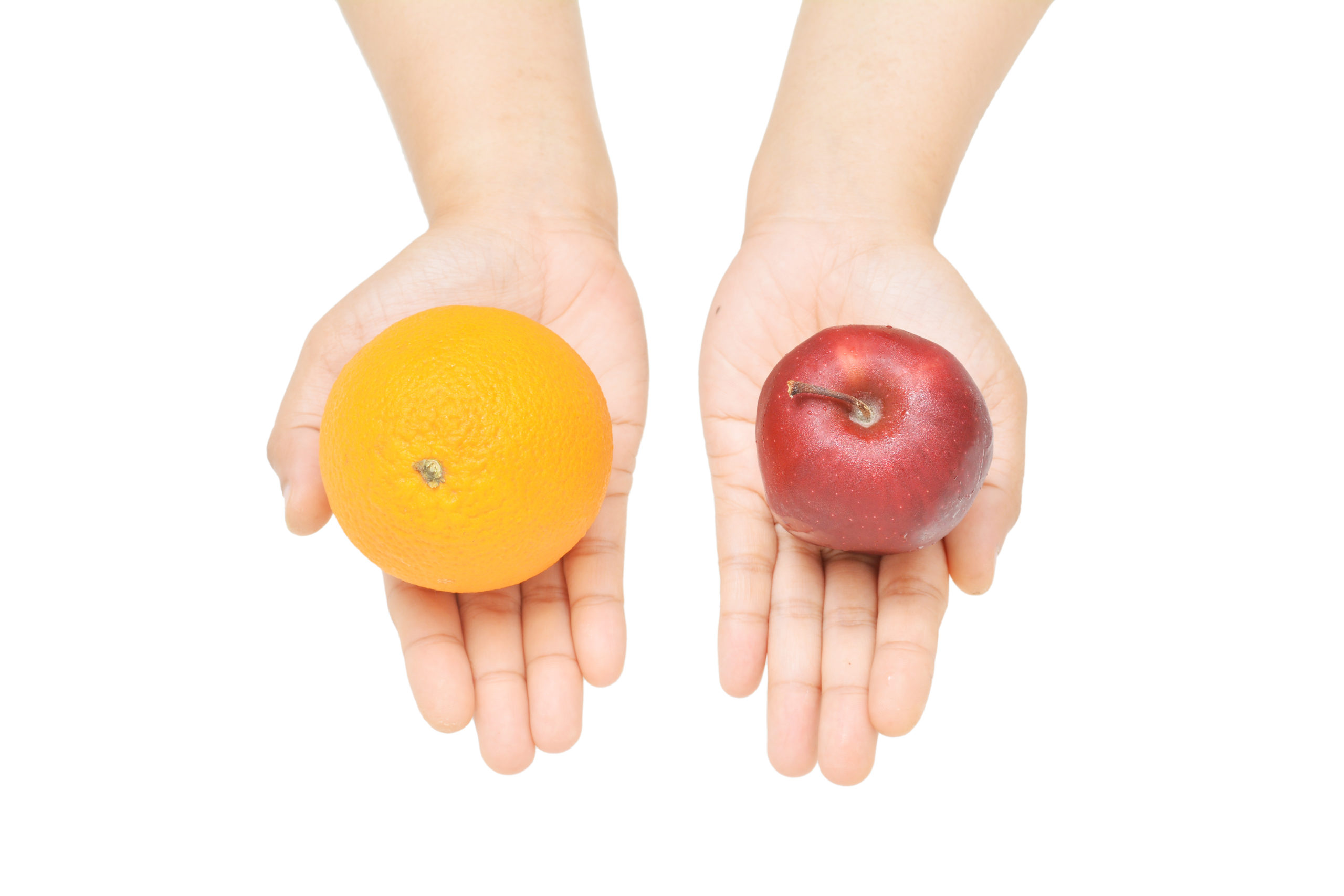 person holding an apple in one hand, orange in another