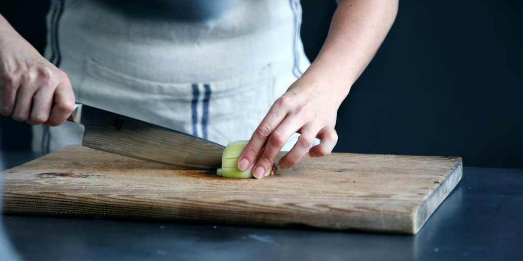 person chopping an onion